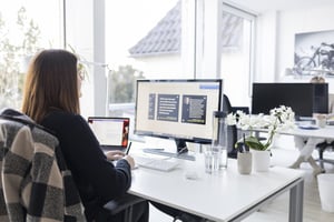 Helles Büro von Blackbit in Göttingen, Frau am Schreibtisch vor ihrem Computer