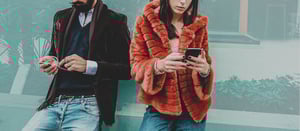 Image detail woman with faux fur jacket and smartphone visualizes the topic of fashion